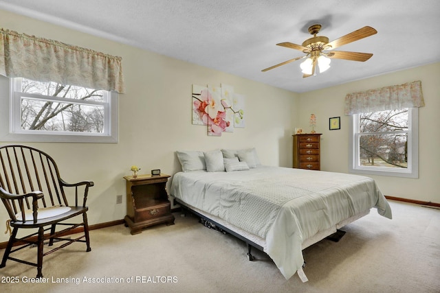 carpeted bedroom featuring a textured ceiling and baseboards