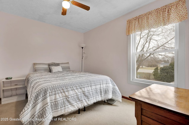 bedroom featuring carpet floors, baseboards, a ceiling fan, and lofted ceiling