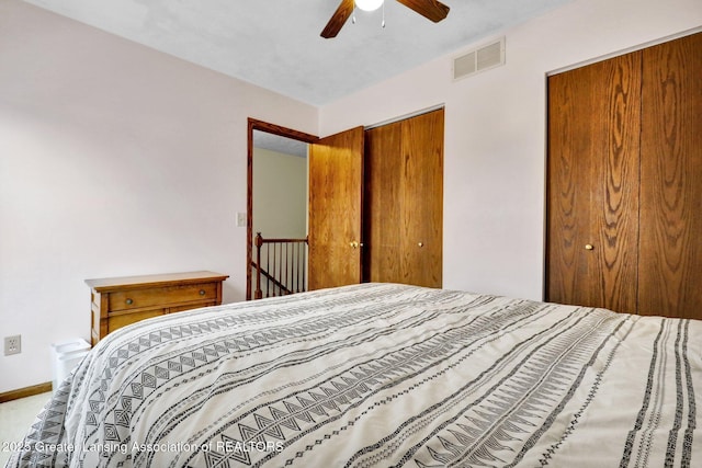 bedroom featuring a ceiling fan, visible vents, and baseboards