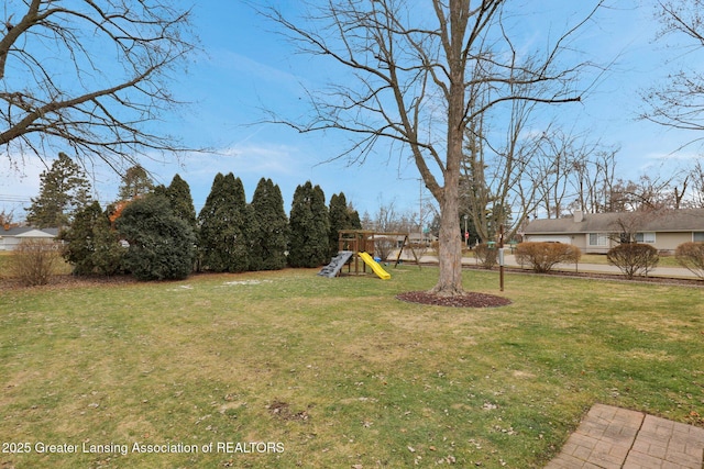 view of yard featuring a playground and fence