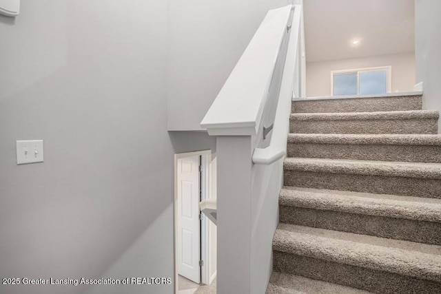 stairs featuring recessed lighting