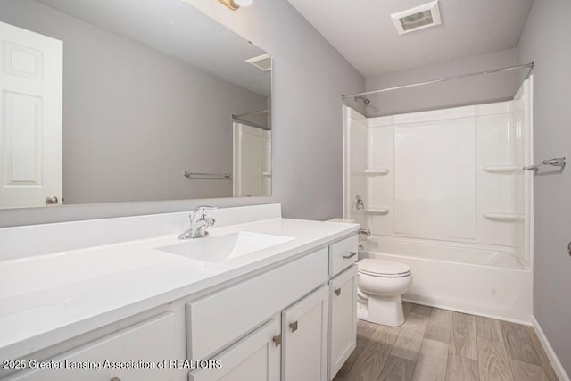 full bathroom featuring visible vents, toilet, shower / tub combination, wood finished floors, and vanity