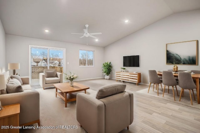 living room with lofted ceiling, light wood-type flooring, a ceiling fan, and recessed lighting