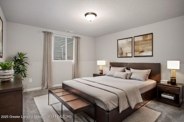 carpeted bedroom with baseboards and visible vents