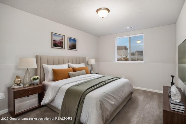 carpeted bedroom featuring visible vents and baseboards