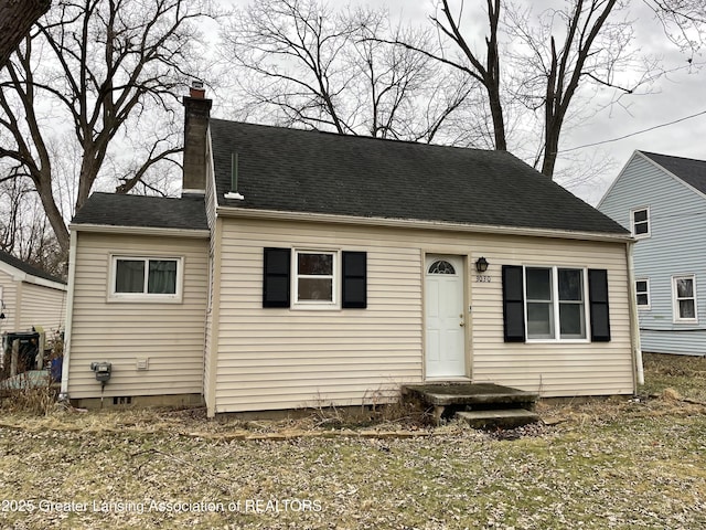 view of front of home featuring a shingled roof and a chimney