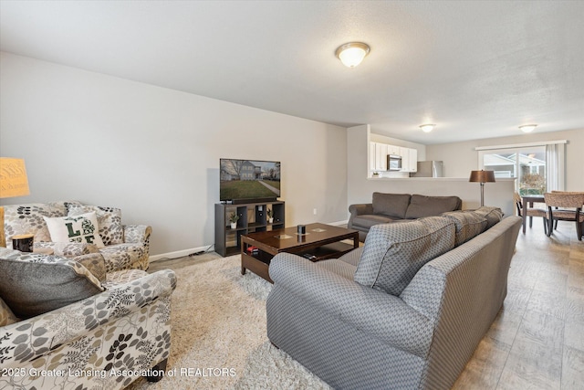 living room with light wood-style floors and baseboards