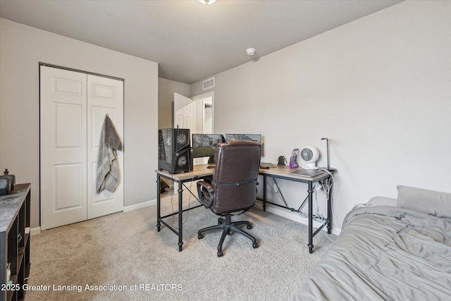 home office with baseboards, visible vents, and light colored carpet