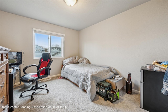 bedroom featuring carpet and baseboards