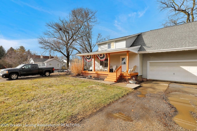 view of front facade featuring driveway, a shingled roof, an attached garage, covered porch, and a front lawn