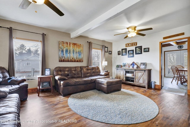 living room with baseboards, wood finished floors, beam ceiling, and a ceiling fan