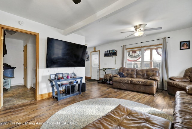 living room featuring ceiling fan, baseboards, beamed ceiling, and wood finished floors