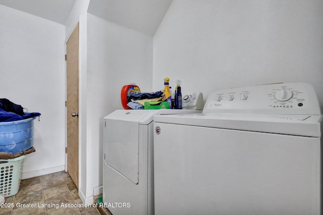 laundry room with laundry area, baseboards, and washer and clothes dryer