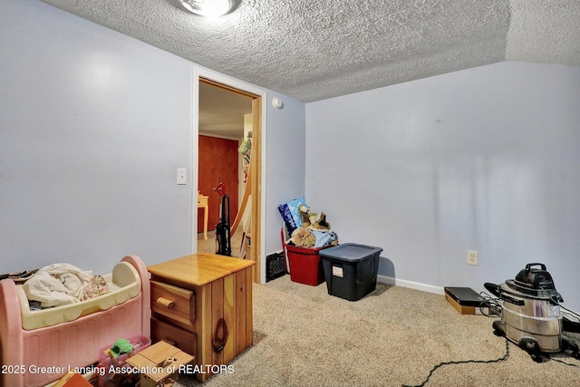 interior space with a textured ceiling, carpet floors, vaulted ceiling, and baseboards