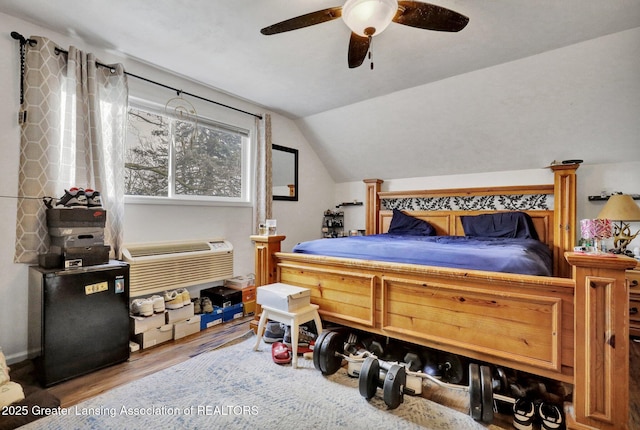 bedroom with vaulted ceiling, ceiling fan, and wood finished floors