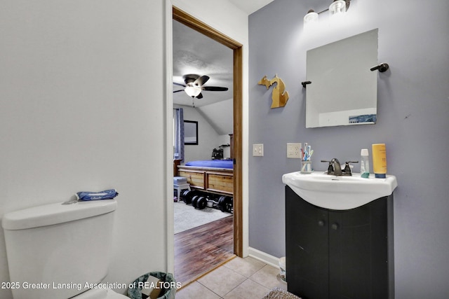 ensuite bathroom featuring toilet, a ceiling fan, connected bathroom, vanity, and tile patterned flooring