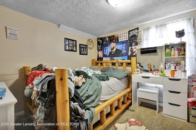 bedroom featuring carpet floors and a textured ceiling