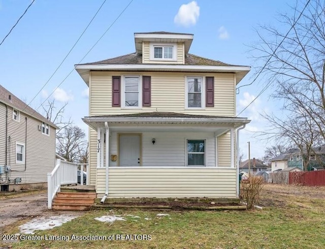 traditional style home featuring a porch and fence