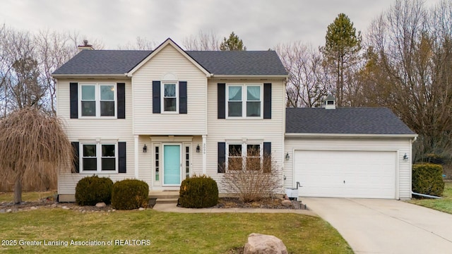 view of front of house featuring driveway, a shingled roof, a chimney, an attached garage, and a front lawn