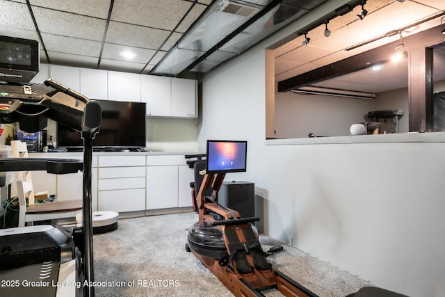 interior space featuring carpet, visible vents, and a drop ceiling