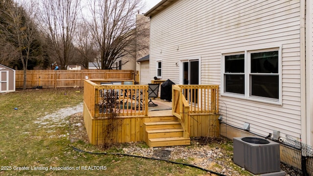 wooden terrace featuring fence, a storage unit, an outdoor structure, and central air condition unit