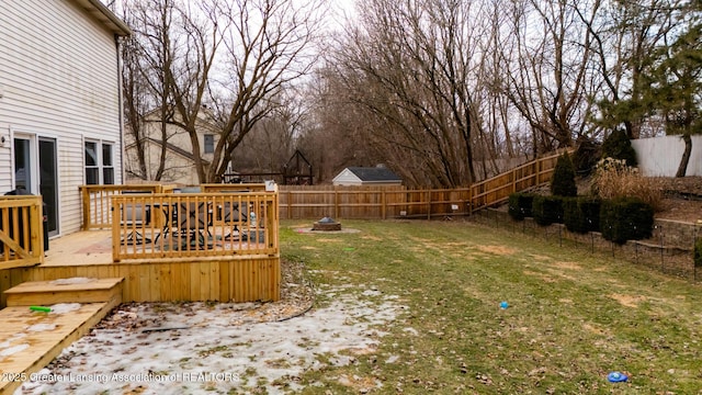 view of yard with an outdoor fire pit, fence, and a wooden deck