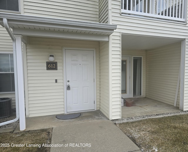 entrance to property with a balcony and central AC unit