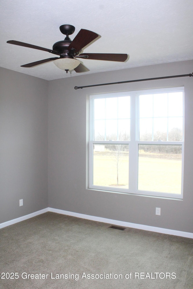 unfurnished room featuring visible vents and baseboards