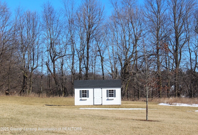 view of shed featuring a view of trees