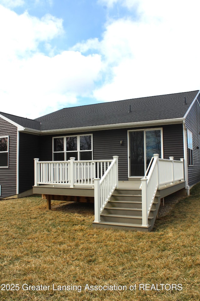 rear view of house with a yard and a deck