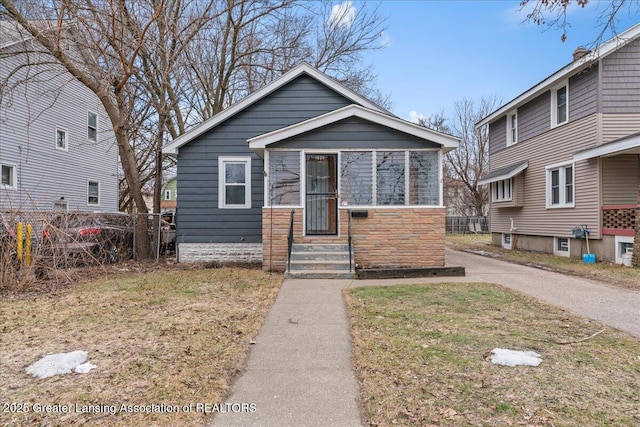 bungalow-style home with fence