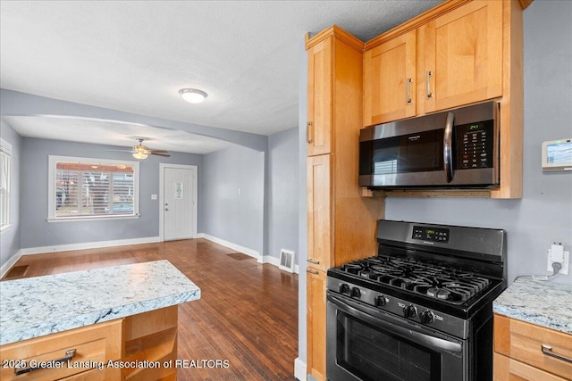 kitchen with baseboards, arched walkways, dark wood-style floors, stainless steel appliances, and light countertops