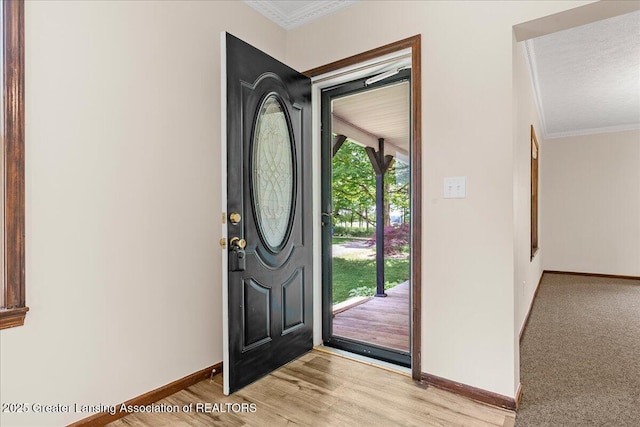 9840 W Herbison Rd, Eagle, MI 48822 - entrance foyer featuring crown molding and light wood-style floors