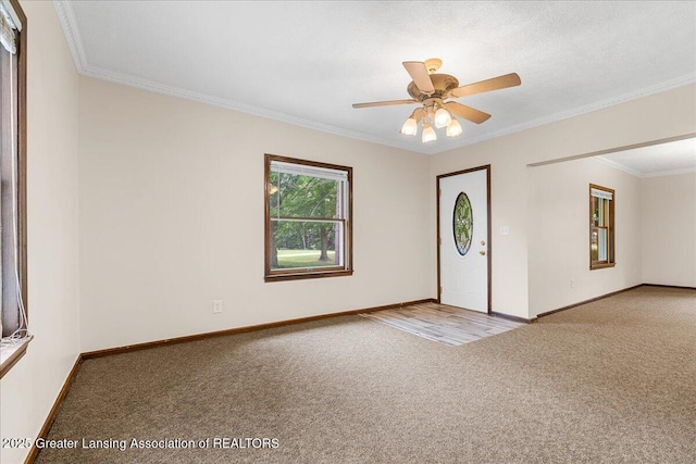 9840 W Herbison Rd, Eagle, MI 48822 - empty room featuring carpet floors, ornamental molding, and a ceiling fan