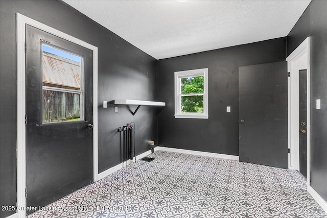 9840 W Herbison Rd, Eagle, MI 48822 - entrance foyer with baseboards and a textured ceiling