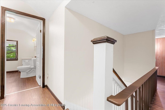 9840 W Herbison Rd, Eagle, MI 48822 - hall featuring an upstairs landing, wood finished floors, and vaulted ceiling