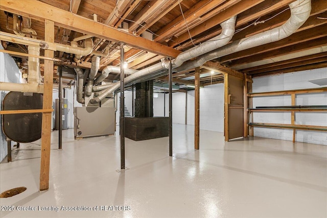 9840 W Herbison Rd, Eagle, MI 48822 - unfinished basement featuring water heater, heating unit, and oil tank