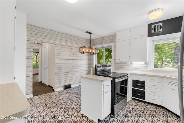 9840 W Herbison Rd, Eagle, MI 48822 - kitchen featuring electric range, white cabinetry, light countertops, and decorative light fixtures
