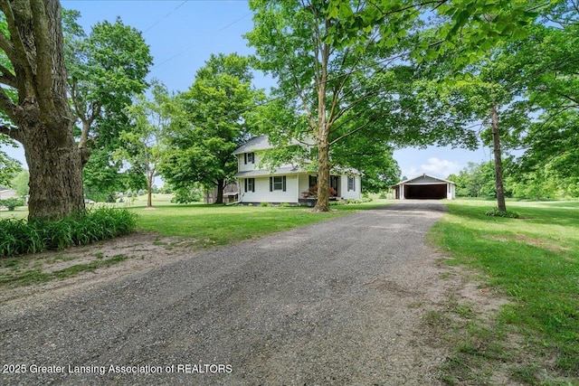 9840 W Herbison Rd, Eagle, MI 48822 - view of property hidden behind natural elements featuring an outdoor structure, a front lawn, driveway, and a detached garage