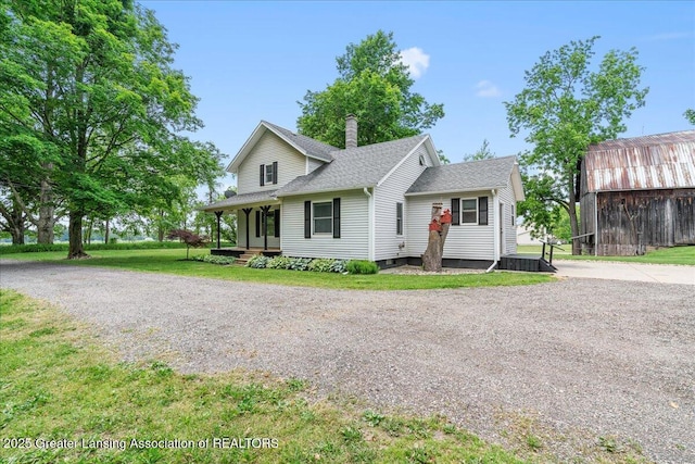 9840 W Herbison Rd, Eagle, MI 48822 - view of front of property featuring a chimney, a front yard, an outdoor structure, and a shingled roof