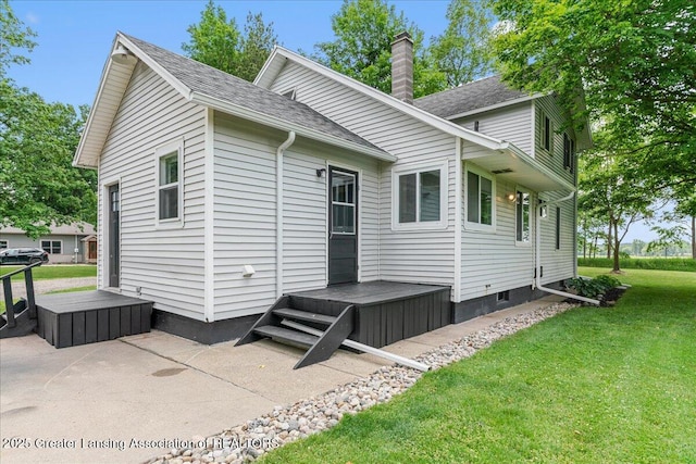9840 W Herbison Rd, Eagle, MI 48822 - view of side of home with a yard, a chimney, roof with shingles, and a patio