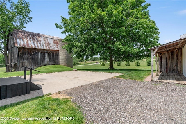 9840 W Herbison Rd, Eagle, MI 48822 - view of grassy yard with an outdoor structure and a barn