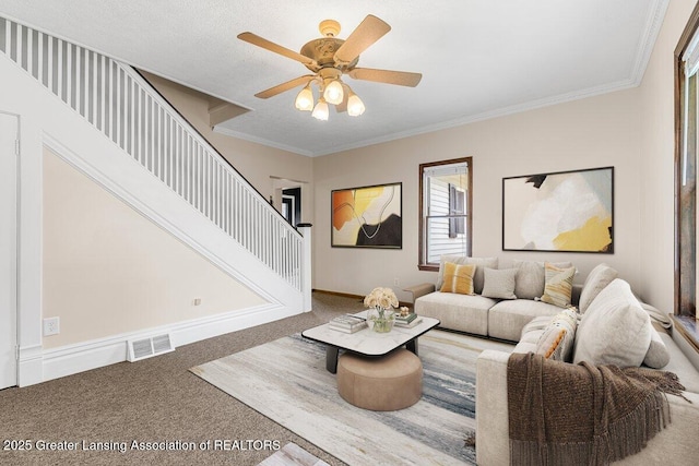 9840 W Herbison Rd, Eagle, MI 48822 - living room featuring carpet floors, stairs, crown molding, and a ceiling fan