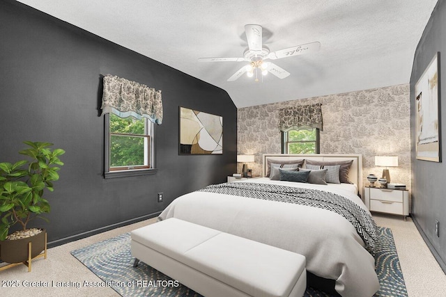 9840 W Herbison Rd, Eagle, MI 48822 - carpeted bedroom featuring vaulted ceiling, a ceiling fan, and a textured ceiling