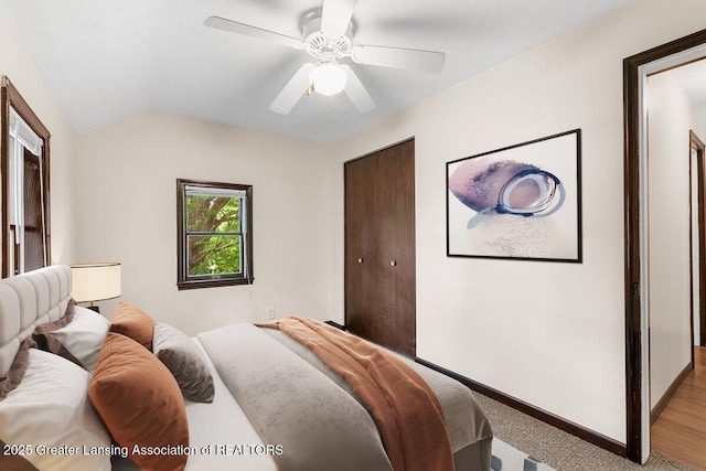 9840 W Herbison Rd, Eagle, MI 48822 - carpeted bedroom with lofted ceiling, ceiling fan, and a closet
