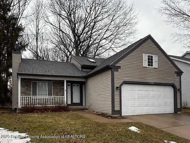 view of front of house featuring a garage, covered porch, a chimney, and concrete driveway