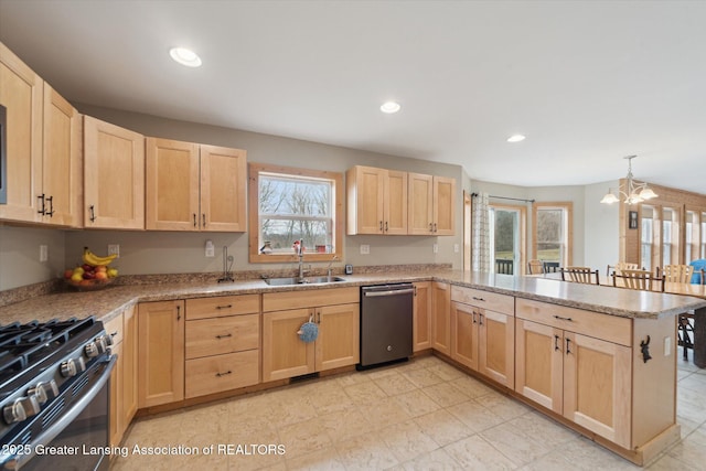 kitchen with stainless steel appliances, light brown cabinets, and a sink