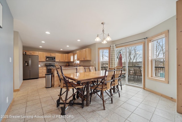 dining area with baseboards, a healthy amount of sunlight, an inviting chandelier, and recessed lighting