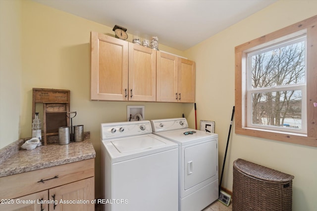 laundry area featuring washing machine and dryer and cabinet space