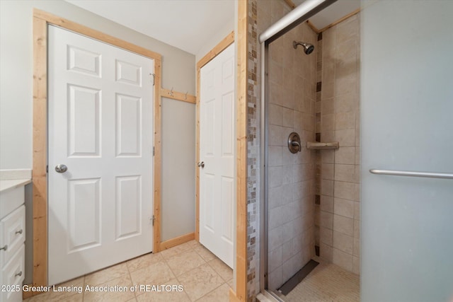 full bathroom with tile patterned flooring and a shower stall